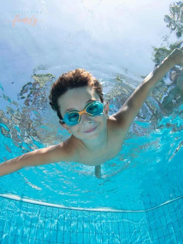 Summer Activities for Families - boy swimming underwater wearing goggles