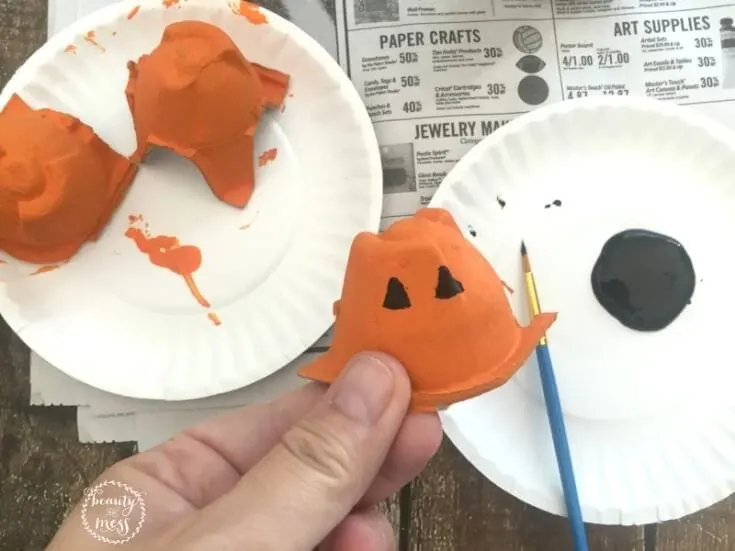 Painting eyes on the pumpkin