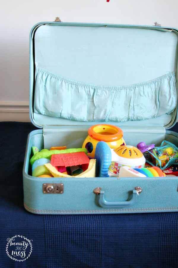 how to store toys in a small space - Vintage Suitcases shown with lid open filled with toys for a child