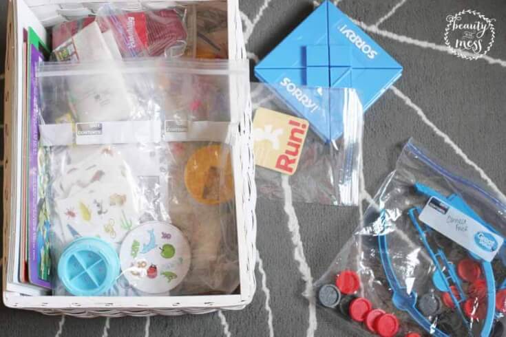 board games stored in baggies to save space stored in a wicker basket