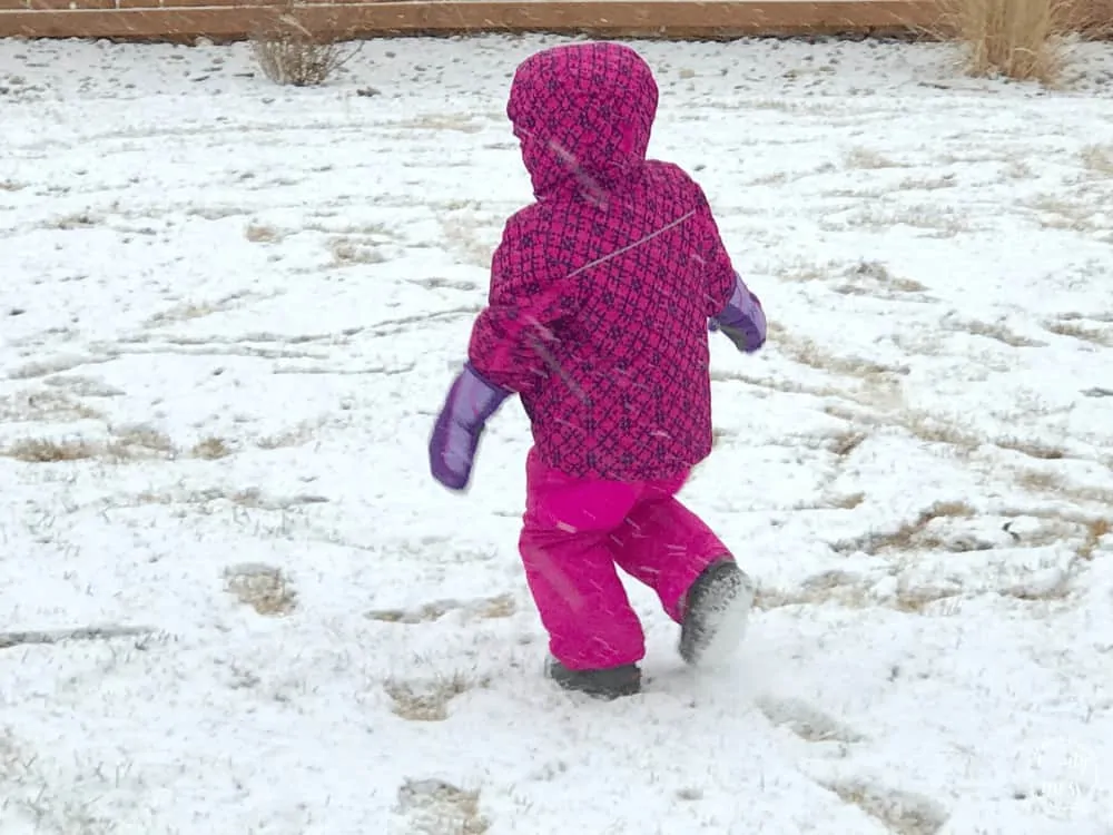 little girl in snow suit Playing in the snow. snow day tips