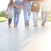 family walking together - ways to give back during the Holidays.