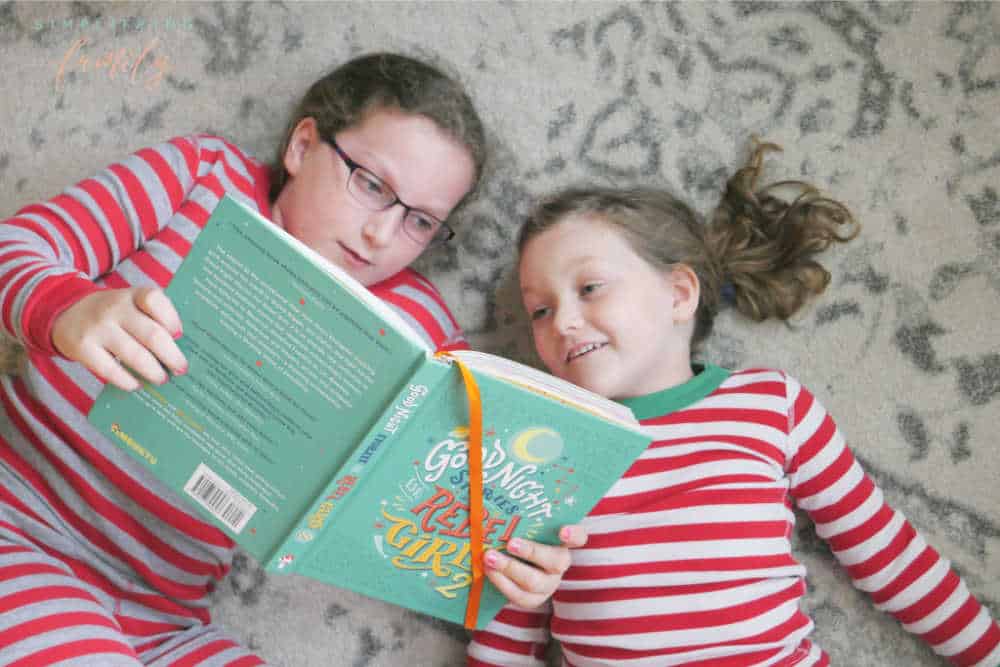 sisters reading rebel girls book before bedtime for a headache free bedtime routine