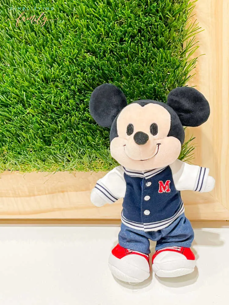 Mickey Mouse Disney nuiMOs standing in front of grass wall with natural wood frame