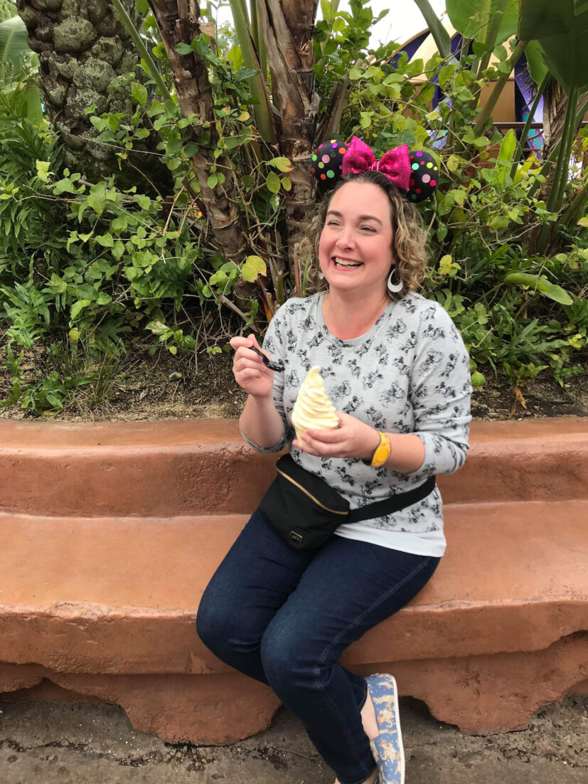 events at Walt Disney World - Whitney eating a Dole Whip and laughing with friends outside of camera frame