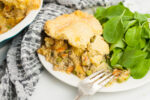 a plate of gluten free chicken pot pie with homemade flakey crust with a fork on plate